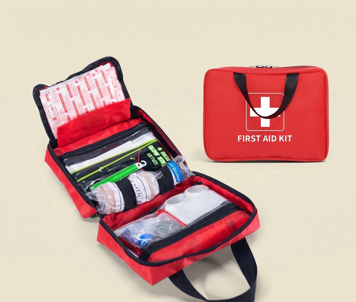 Open red Trygghetslagret first-aid kit beside its closed carry case